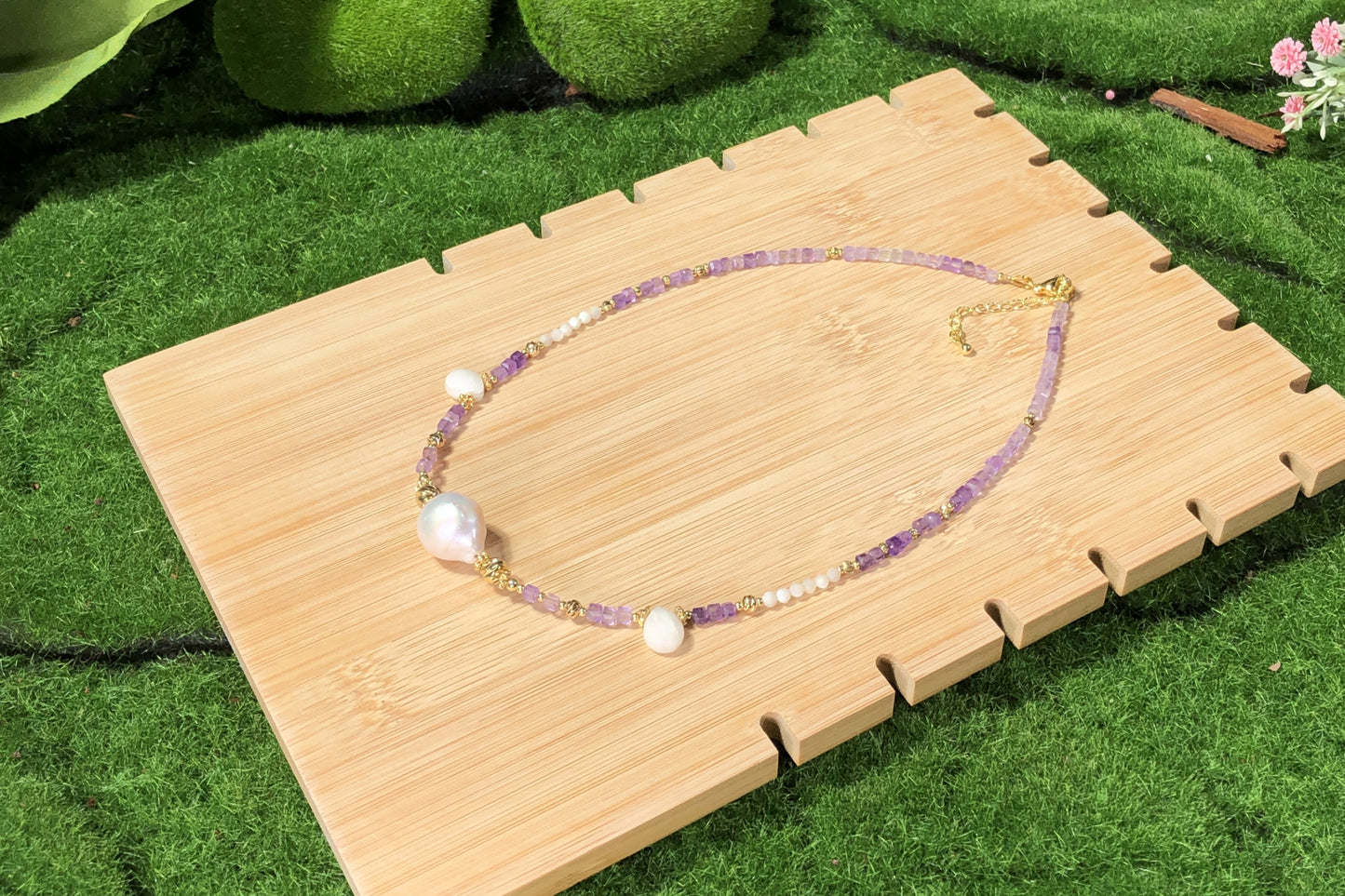 Eine handgefertigte Halskette aus natürlichen Barockperlen und Amethysten, kombiniert mit einer 14-karätig kupferplattierten Goldkette.